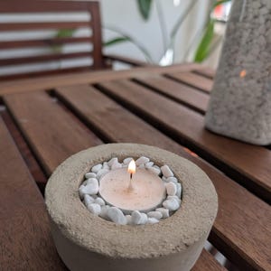 Può includere: Una tazza di ceramica bianca con manico nero e la scritta "But First, Coffee" in grassetto nero. La tazza è posta su uno sfondo sfocato, che suggerisce un'atmosfera accogliente.