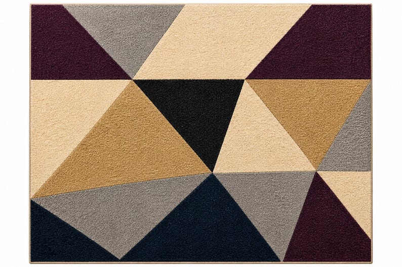 May include: A rectangular area rug featuring a geometric pattern composed of various triangles in shades of deep purple, black, dark navy blue, light beige, and medium gray. The rug has a textured surface and a thin, solid-colored border.