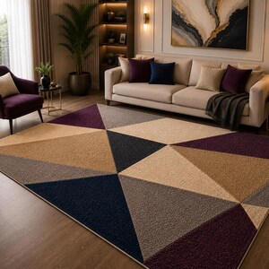 May include: A large area rug featuring a geometric pattern of triangles in shades of deep purple, navy blue, beige, and gray. The rug has a textured, tufted surface and covers a significant portion of the floor in a living room setting.