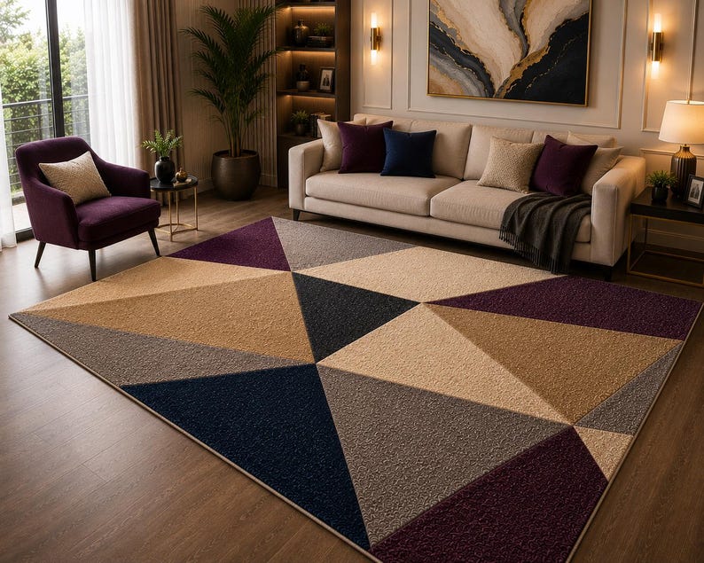 May include: A large area rug featuring a geometric pattern of triangles in shades of deep purple, navy blue, beige, and gray. The rug has a textured, tufted surface and covers a significant portion of the floor in a living room setting.
