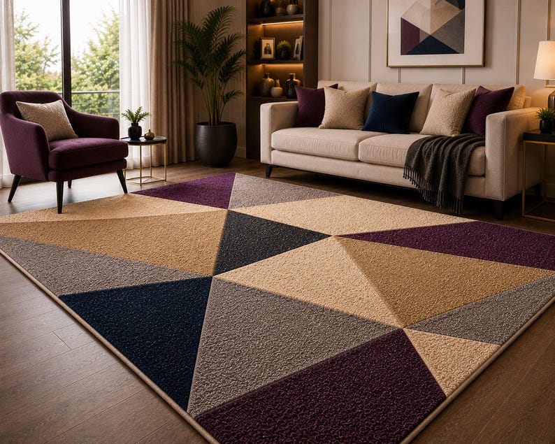 May include: A rectangular area rug featuring a geometric pattern of large triangles in shades of deep purple, navy blue, beige, and gray. The rug has a textured, pile surface and is finished with a clean, bound edge, covering a wooden floor.
