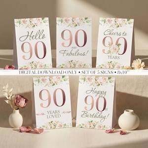 May include: A set of five printable signs, each 20x25 cm, featuring the number 90 in rose gold with floral decorations. The signs display phrases like "Hello 90", "90 and Fabulous!", and "Happy 90th Birthday!" for a milestone celebration.