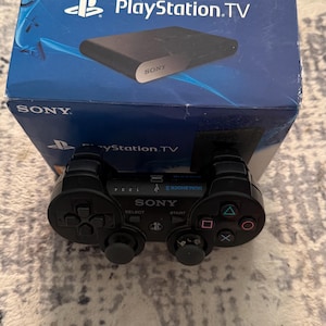 May include: A white ceramic mug with a black handle and the text "But first, coffee" in a handwritten style. The mug is on a white surface. The mug is likely for hot beverages.