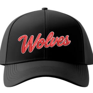 May include: A black baseball cap featuring the word Wolves written in a stylized red script font with a white outline across the front panels. The cap has a structured crown, a curved brim, and a central seam running vertically down the front.