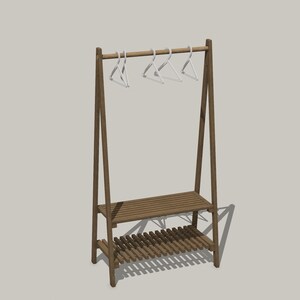 May include: A brown wooden A-frame garment rack featuring a horizontal hanging rod with four white plastic hangers attached. The structure includes two slatted shelves positioned at the lower section for storage, supported by angled side legs.