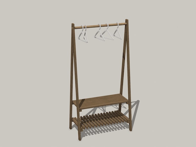 May include: A brown wooden A-frame garment rack featuring a horizontal hanging rod with four white plastic hangers attached. The structure includes two slatted shelves positioned at the lower section for storage, supported by angled side legs.