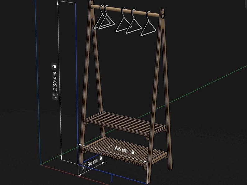 May include: A brown wooden A-frame garment rack with two slatted shelves and a top hanging rod holding four white hangers. The structure features technical dimension labels showing a height of 130 mm, a width of 66 mm, and a depth of 36 mm.