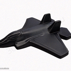 May include: A black jet airplane model with a sleek design. The model features wings, a cockpit, and tail fins. The jet is made of a solid material and is displayed against a white background. The text "@sethmadecreations" is visible at the bottom.