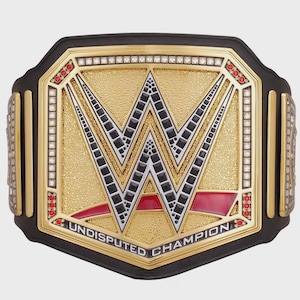 May include: A gold and black wrestling championship belt with the letters "W" in the center. The belt has red and white accents, and the words "UNDISPUTED CHAMPION" are printed on the bottom.