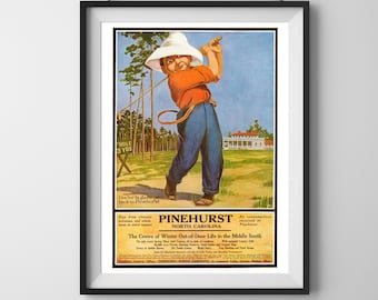 May include: Framed vintage advertisement for Pinehurst, North Carolina, featuring a cartoon illustration of a golfer swinging a club. The golfer wears an orange shirt, blue pants, and a white hat. Text includes "Hole 5 Yds" and "The Centre of Winter Out-of-Door Life."