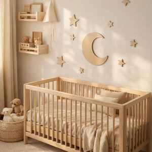 May include: A light wood crib with a neutral-toned bedding set. The nursery features wooden star and moon wall decor. Two small wooden shelves hold decorative items, including teddy bears. A woven basket holds stuffed animals.