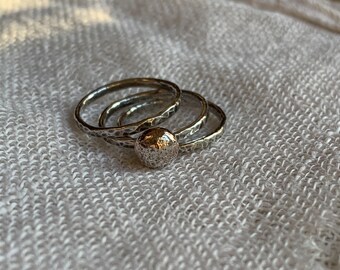 Three sterling silver hammered stacking rings with silver ball