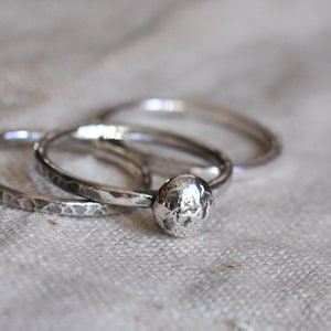 Three sterling silver hammered stacking rings with silver ball