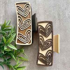 May include: A set of three ceramic mugs with a speckled, matte finish. The mugs are in shades of cream, light brown, and dark brown. Each mug has a simple, minimalist design, perfect for coffee or tea.