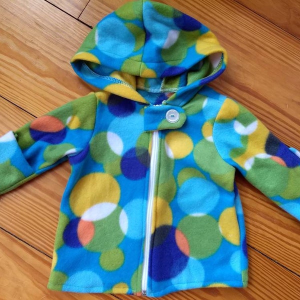 Handmade baby hoodie with zipper and fold over cuffs in a bright circle print. Size 12 months