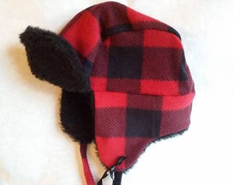 Buffalo plaid toddler trapper hat fits up to 18 inches around. Made of fleece and polyester fur lining with fleece ties.