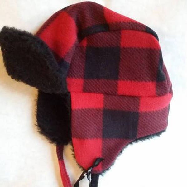 Buffalo plaid toddler trapper hat fits up to 18 inches around. Made of fleece and polyester fur lining with fleece ties.