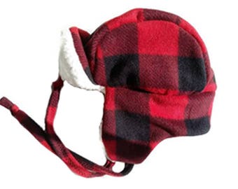 Winter trapper hat for adults in a buffalo plaid with cream or black colored sherpa lining to keep you warm. Fits up to 25" around.