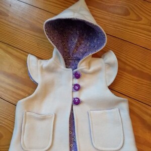 Pixie vest in a warm fleece lined with flannel. Button closure and flutter sleeve caps.