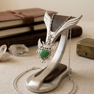 Green aventurine healing crystal pendant featuring polished heart stone and vintage inspired sterling silver setting.