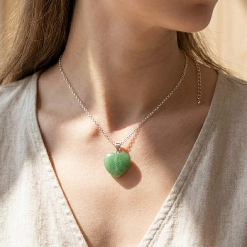 Handmade certified green fluorite crystal heart pendant in silver setting designed as heart chakra healing jewelry.