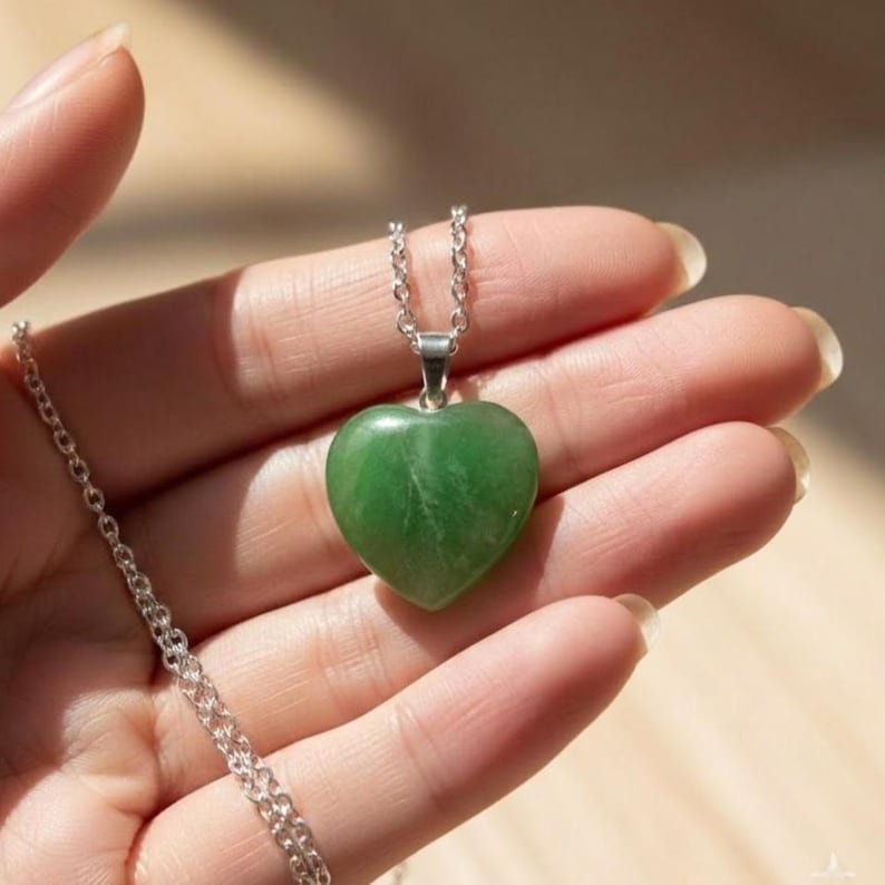 Certified green fluorite heart pendant necklace featuring natural polished translucent green crystal set in sterling silver, perfect for heart chakra healing jewelry.