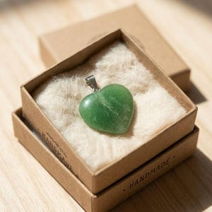 Natural green fluorite gemstone heart necklace with polished surface and calming green tones for chakra balancing wear.