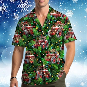 May include: A short-sleeve button-down shirt featuring a repeating pattern of red tractors decorated with Christmas wreaths and bows, set against a background of green pine branches and colorful glowing holiday string lights.