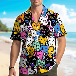 May include: A short-sleeve button-down shirt featuring a vibrant, all-over cartoon print of cats in various colors including black, white, yellow, pink, and blue. The cats are depicted with diverse expressions, some wearing small crowns or bows.