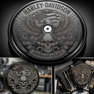 May include: Black Harley-Davidson motorcycle air cleaner cover with engraved design. Features an eagle, American flag, skull, and the words "HARLEY-DAVIDSON" and "AMERICAN LEGACY". Includes the phrases "LIVE TO RIDE" and "TO RIDE".