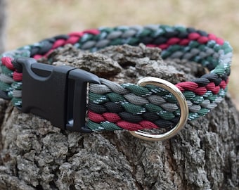 May include: A braided dog collar in red, black, green, and grey with a black plastic buckle and a silver metal D-ring.