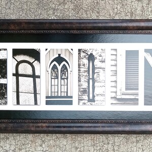 May include: A rectangular wall art piece featuring the word FAMILY spelled out in six individual black and white photographs of architectural elements, enclosed in a dark brown textured frame with a white mat and a black inner border.