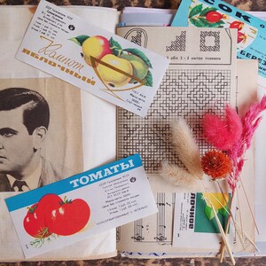 May include: A vintage scrapbook page with a black and white portrait, colorful product labels, and dried flowers. The labels feature illustrations of apples and tomatoes, with text in Cyrillic script.