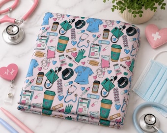 May include: Folded fabric with a pink backdrop, patterned with medical illustrations. The design includes scrubs, stethoscopes, coffee cups, and medical equipment in teal, blue, and pink. A stethoscope and other medical accessories are visible.