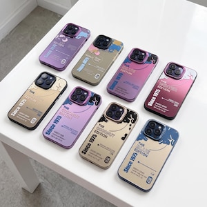 May include: Eight rectangular smartphone cases featuring various color gradients and graphic designs. Each case displays text including Since 1975, The Winter Edition, The Coconut Edition, or The Blue Edition, along with energy drink branding details.