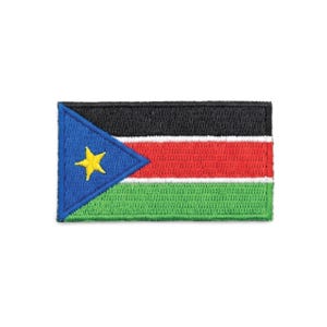 May include: Embroidered patch depicting the flag of South Sudan. The rectangular patch has a black top, red centre, and green bottom. A blue triangle with a yellow star is on the left side. The patch is likely for clothing or accessories.