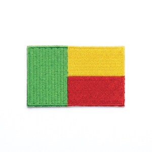 May include: Embroidered patch featuring the flag of Benin. The rectangular patch displays the flag's colors: green, yellow, and red. The green section is on the left, followed by yellow and red vertical stripes. The patch is likely for clothing or accessories.