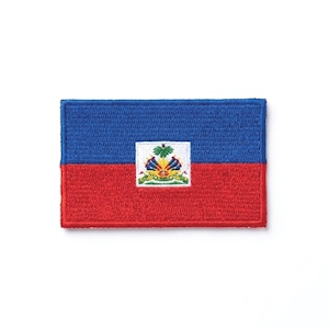 May include: Embroidered patch featuring the flag of Haiti. The flag is divided horizontally, with a blue upper section and a red lower section. The center features the Haitian coat of arms.