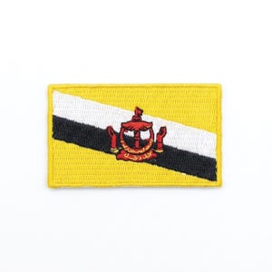 May include: Embroidered patch featuring the flag of Brunei. The flag has a yellow background with a white and black diagonal stripe. The emblem of Brunei is in the center, in red. The patch has a yellow border.