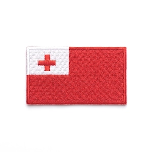 May include: Embroidered patch featuring the flag of Tonga. The rectangular patch has a red background with a white square in the upper left corner. A red cross is centered in the white square.