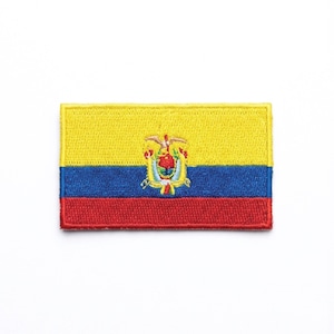 May include: Embroidered patch featuring the flag of Ecuador. The rectangular patch has a yellow upper section, a blue middle section, and a red lower section. The Ecuadorian coat of arms is centered on the yellow and blue sections.