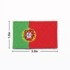 May include: Embroidered patch featuring the flag of Portugal. The rectangular patch is divided into green and red sections, with the Portuguese coat of arms in the center. The patch measures 2.5 inches wide and 1.5 inches high.