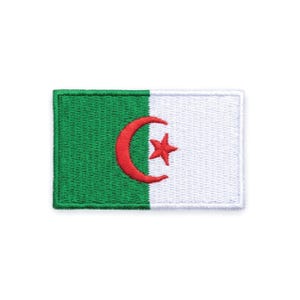May include: Embroidered patch featuring the flag of Algeria. The design includes a green field on the left, a white field on the right, and a red crescent moon and star in the center. The patch is rectangular.