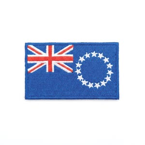 May include: A rectangular patch featuring the flag of the Cook Islands. The flag has a blue background with the Union Jack in the upper left corner and a ring of fifteen white stars on the right side.