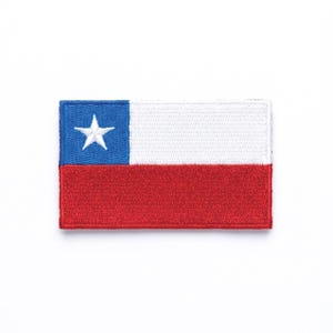 May include: Embroidered patch featuring the flag of Chile. The design includes a blue square with a white star in the upper left corner, a white rectangle, and a red rectangle. The patch is rectangular and has a white border.