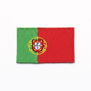 Puede incluir: Parche bordado con la bandera de Portugal. El diseño se divide verticalmente, con un campo verde a la izquierda y un campo rojo a la derecha. El escudo de armas portugués está centrado en el campo rojo.