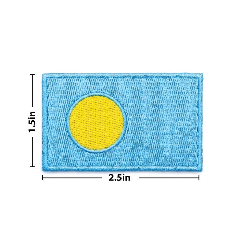 May include: Embroidered patch featuring the flag of Palau. The rectangular patch is light blue with a yellow circle and measures 2.5 inches wide and 1.5 inches high. The flag design is stitched with a light blue border.