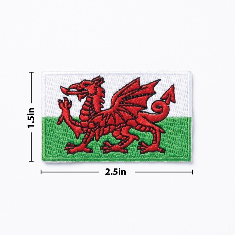 May include: Embroidered patch of the Welsh flag, featuring a red dragon on a white and green background. The patch measures 6.35 cm wide and 3.81 cm high.