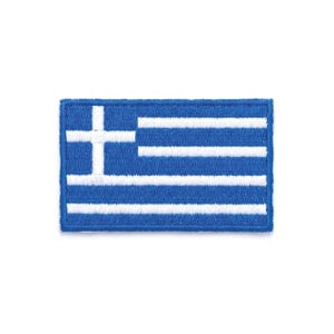 Puede incluir: Un parche rectangular con la bandera griega. La bandera es azul con nueve franjas horizontales alternas azules y blancas. Una cruz blanca está situada en la esquina superior izquierda.