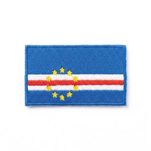 May include: A rectangular blue patch depicting the flag of Cape Verde. The design features a white and red horizontal stripe, with a ring of ten yellow stars around the centre. The patch has a blue border.